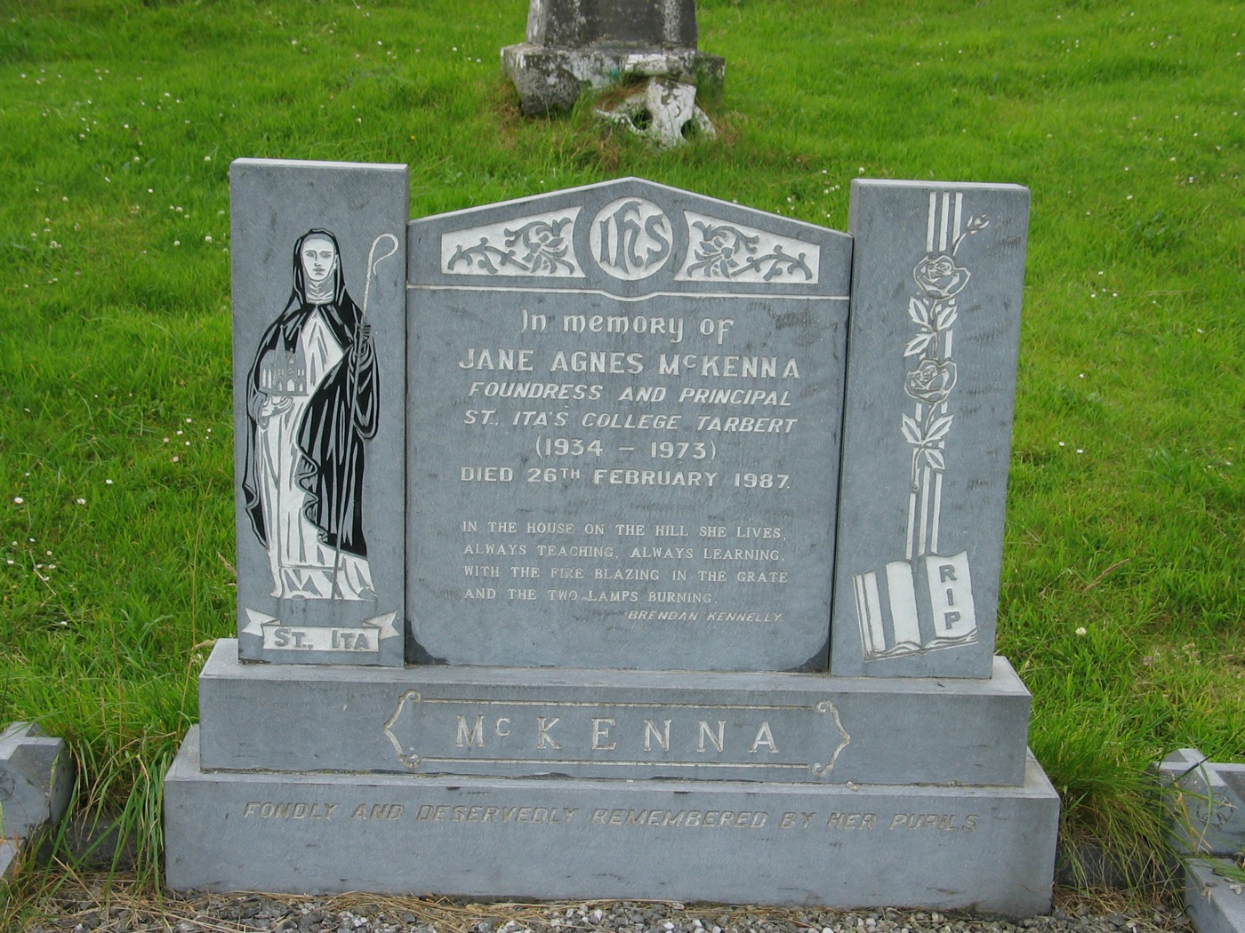 Close-up of Jane Agnes McKenna memorial with St Ita carving and St Ita's College Tarbert inscription.