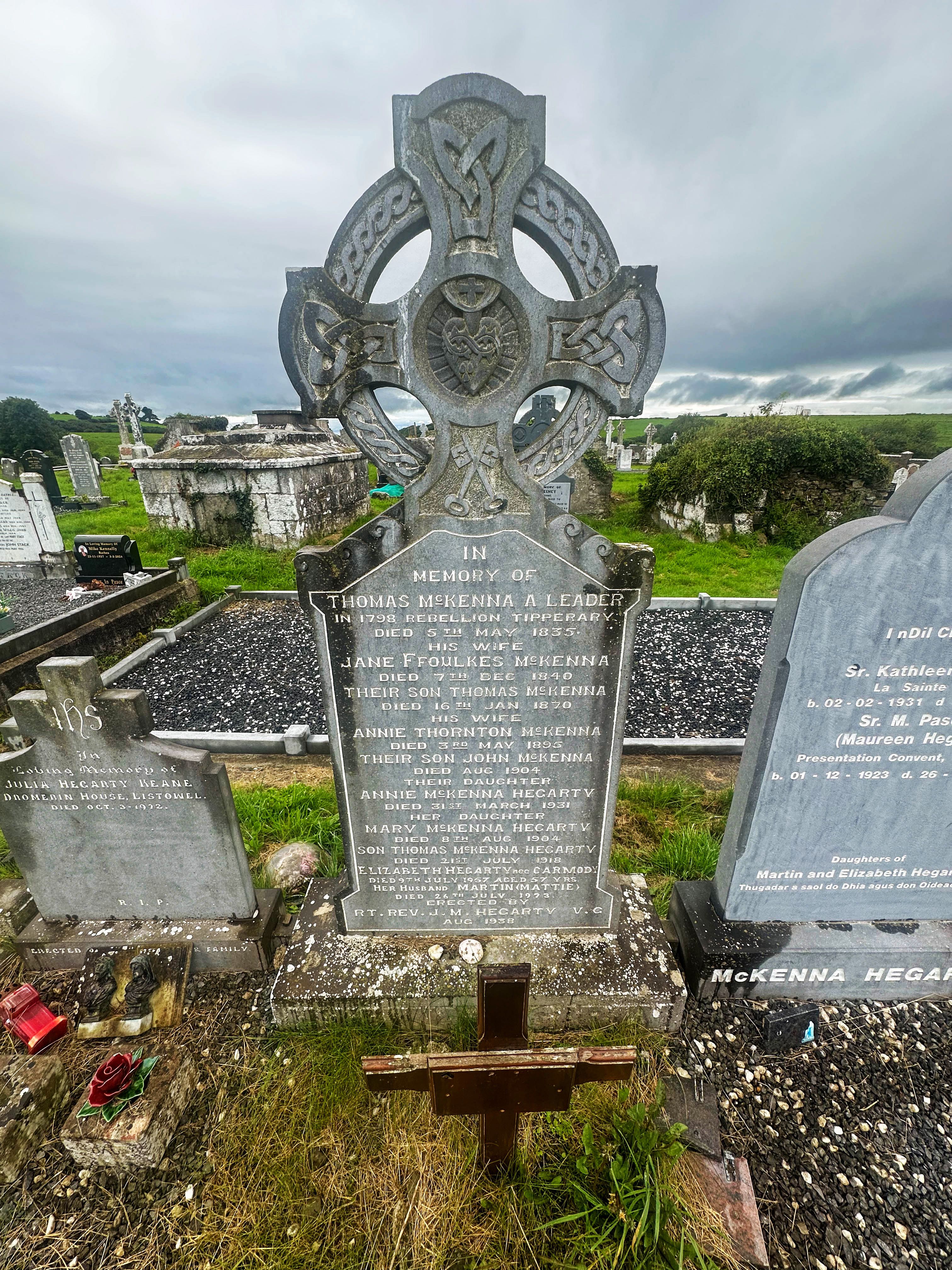 Kilshenane Celtic-cross headstone with the inscription beginning 'THOMAS McKENNA A LEADER IN 1798 REBELLION TIPPERARY DIED 5TH MAY 1835', set among adjoining Hegarty plots.